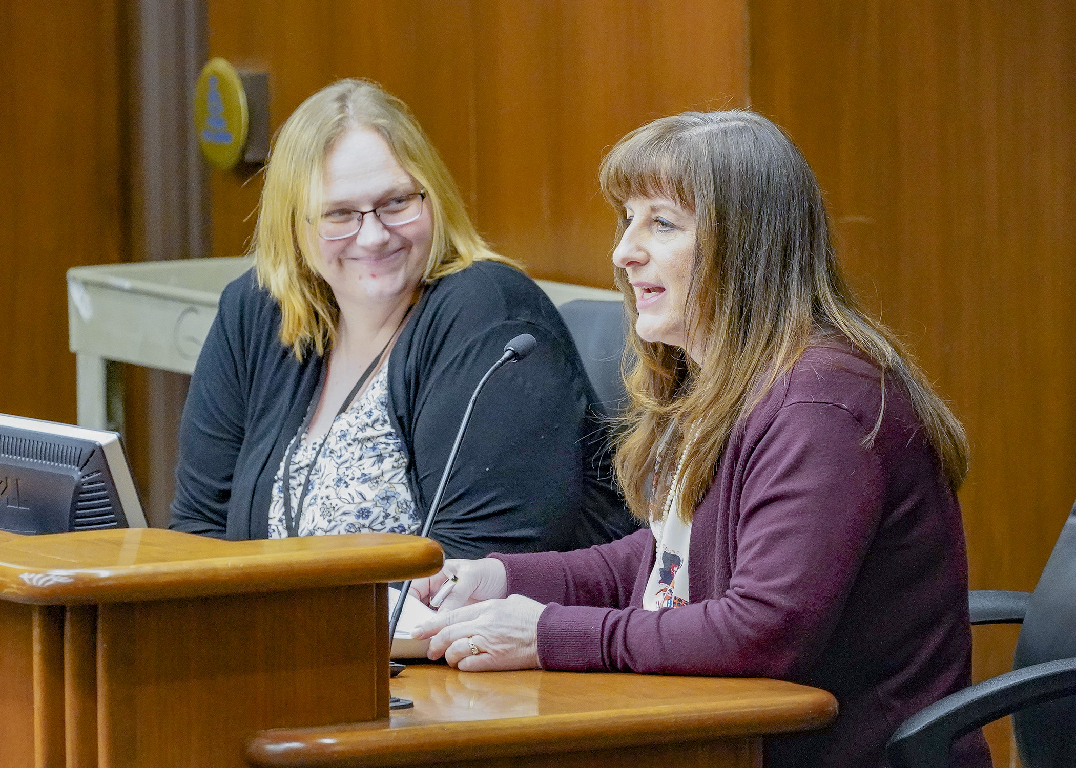 Hiawatha Homes CEO Cindy Ostrowski testifies before House lawmakers Feb. 6 in support of a bill to establish home- and community-based workforce incentive fund grants. Rep. Kim Hicks, left, sponsors the bill. (Photo by Andrew VonBank)